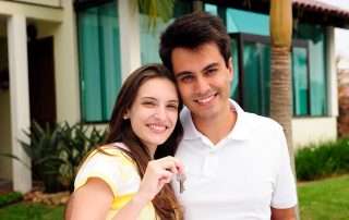 First-time homebuyers with keys at new home