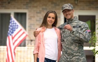 Soldier and wife showing keys to their new home.
