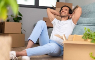 Young man takes a break from moving into his new home