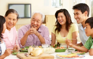 A multigenerational Asian family sharing a meal at home