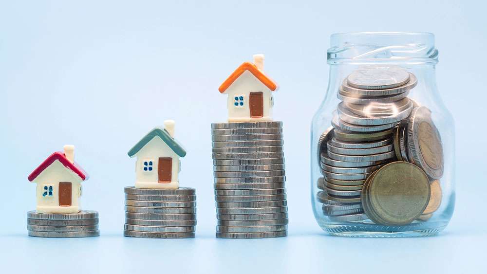 Building Real Estate Wealth: Sustainable Long-Term Investment Strategies Miniature houses on increasingly taller stacks of coins.