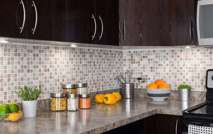 Kitchen remodel with new countertop, backsplash, under-cabinet lighting, and new cabinet doors and hardware.