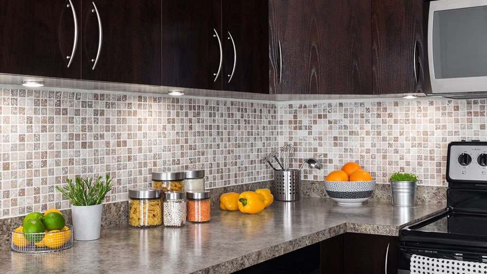 Budget-Friendly Kitchen Remodel: 10 High-Impact Changes Kitchen remodel with new countertop, backsplash, under-cabinet lighting, and new cabinet doors and hardware.