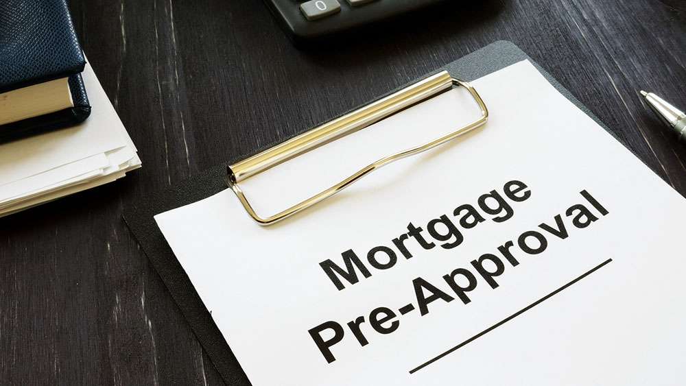 Mortgage Pre-Approval 101: Getting Ready to Make an Offer Mortgage Pre-Approval papers on a clipboard sitting on a desk.